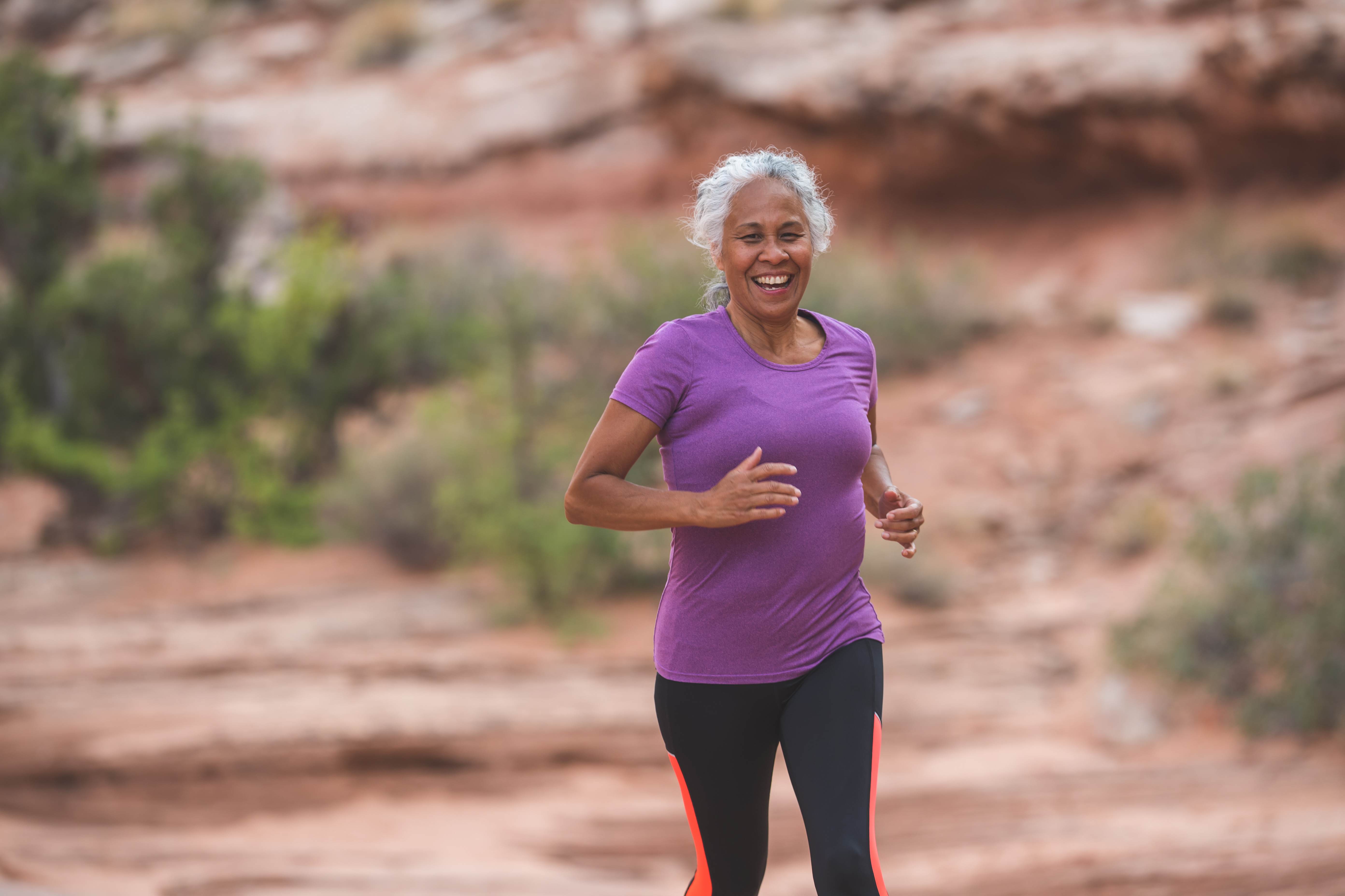 Photo of an elderly woman happy running