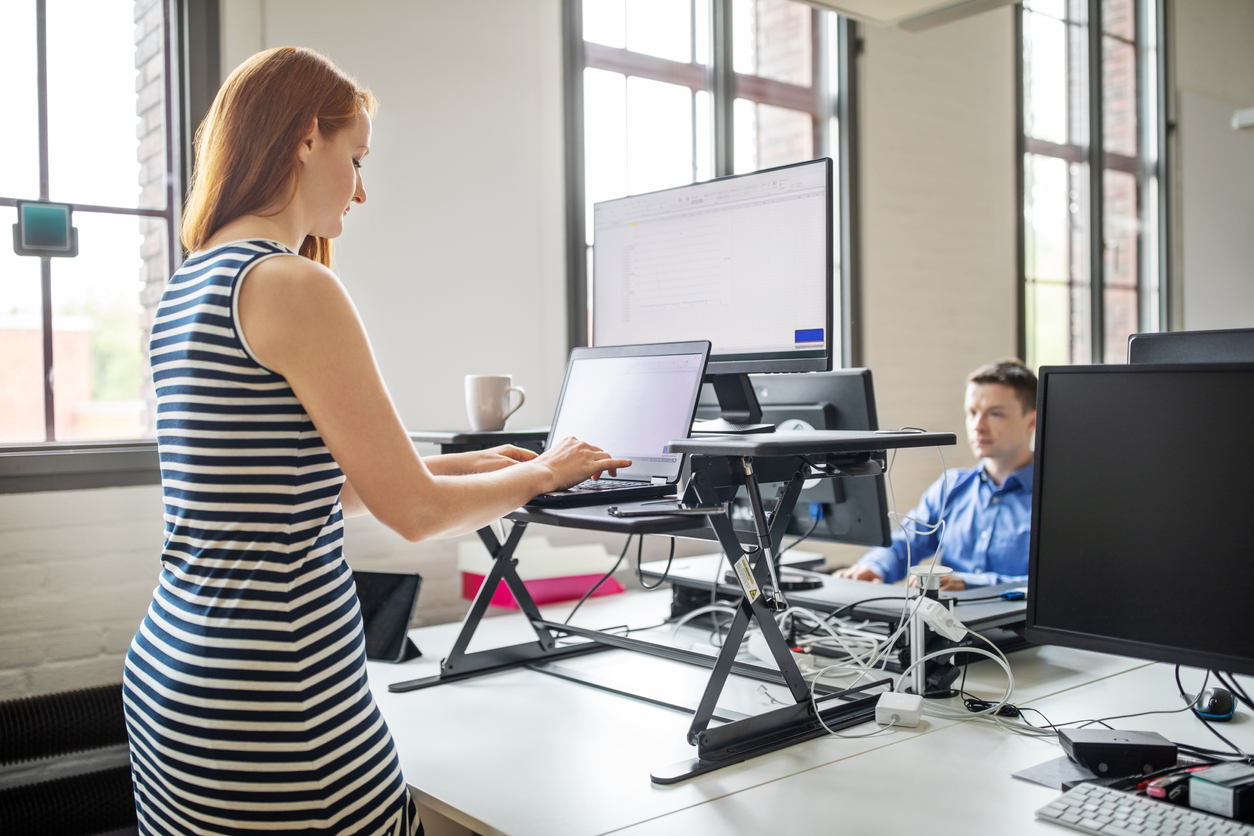 women-working-while-standing-laptop