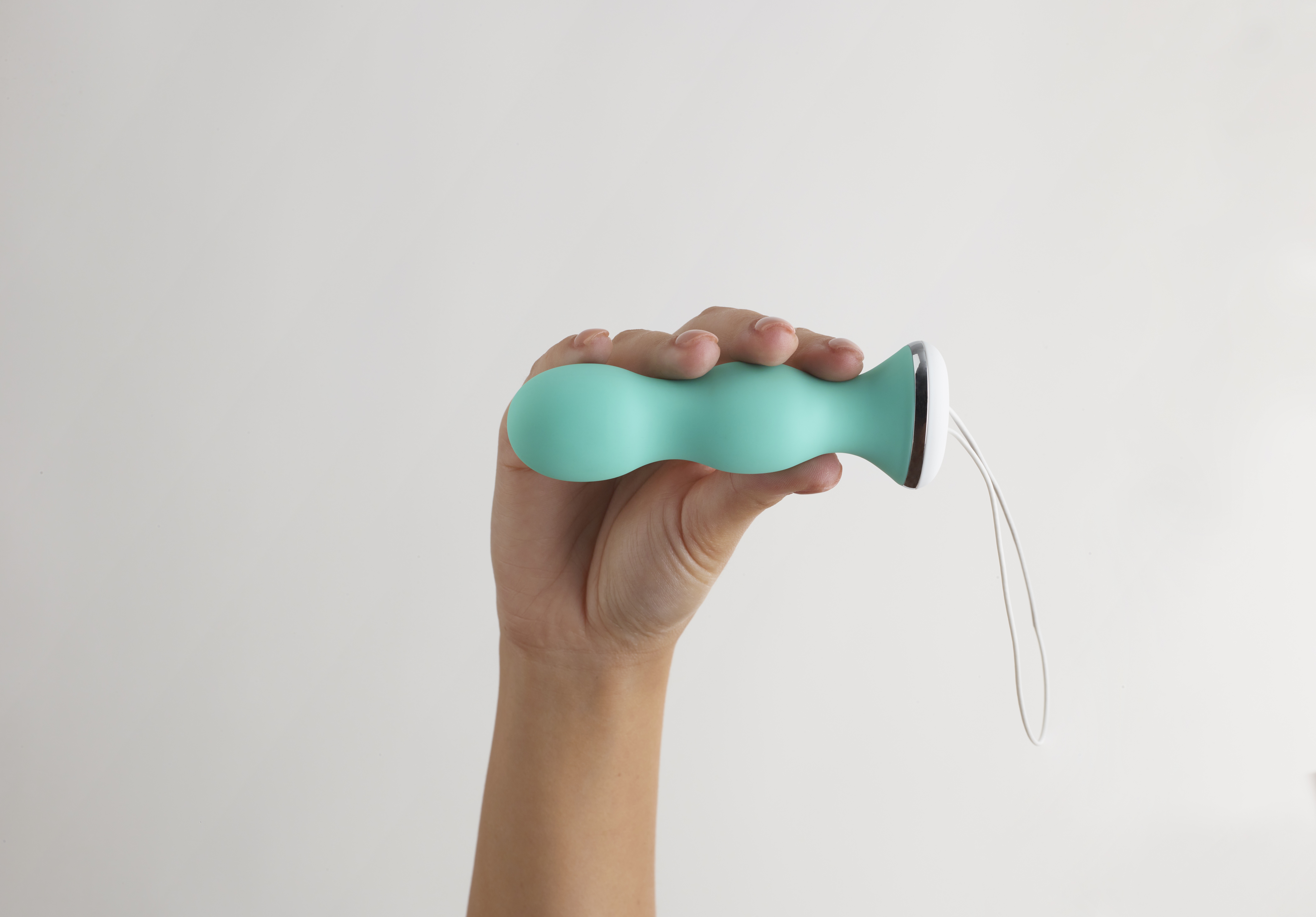 Image of a hand holding a pelvic trainer